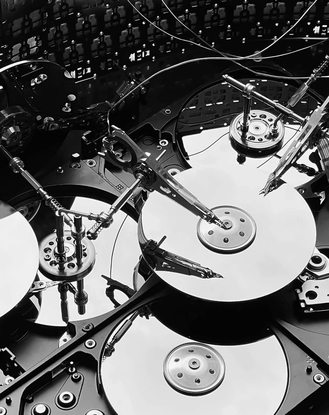 Data Democracy concept model — actuator arms and platters of dismantled hard drives rebuilt as a memory machine