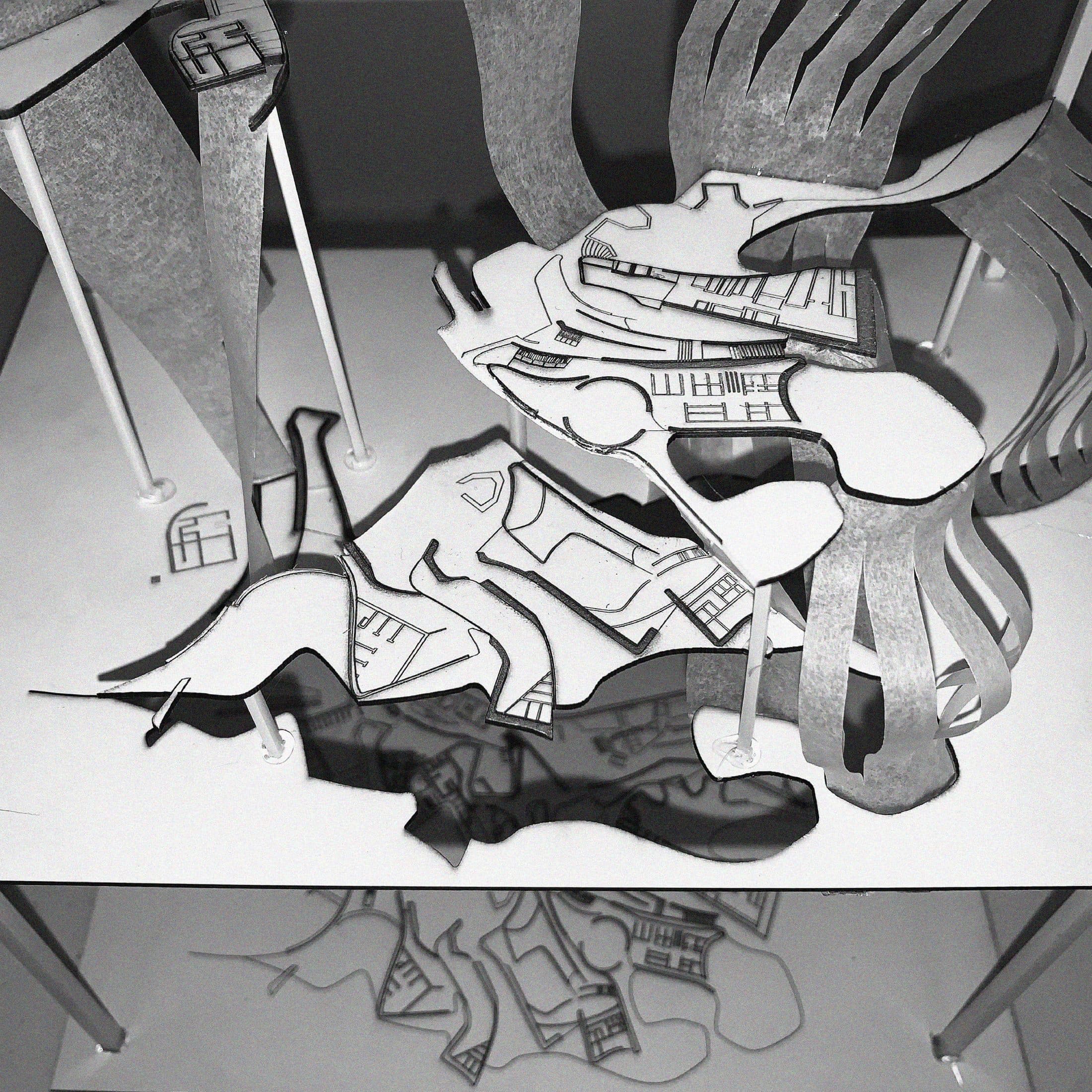 Layered cut-paper model — plans and elevations stacked as strata of the wall