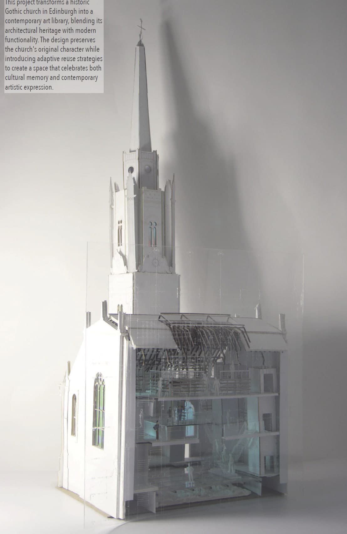 Model of the Tron Kirk — white spire and Gothic shell with a translucent drawing screen rising behind, the sectional interior glowing pale green